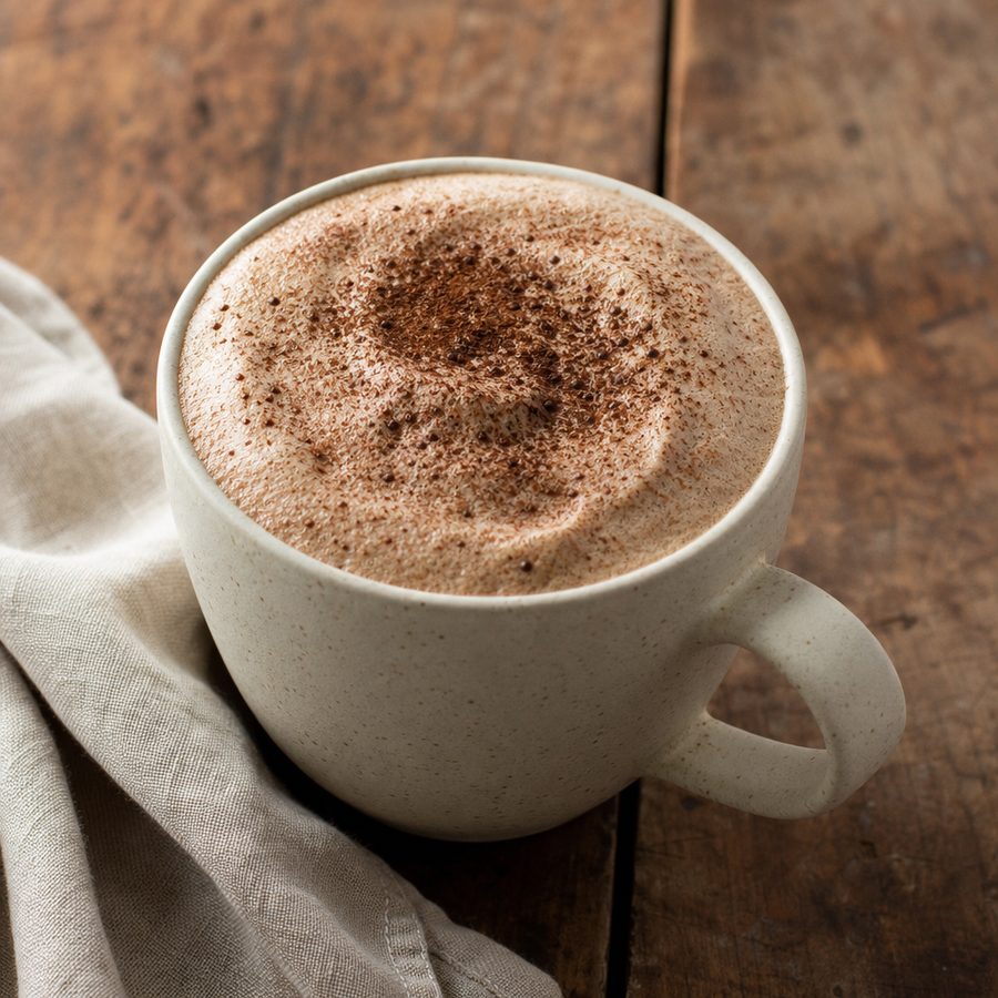 Mushroom cacao coffee in a mug dusted with cocoa